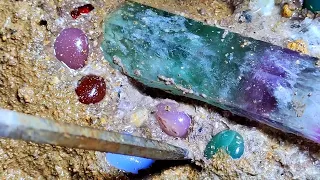 Huge watermelon tourmaline surrounded by agate balls