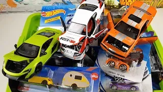 A box full of various types of small and large cars