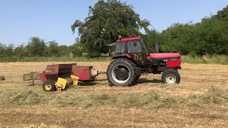 Case 1594 bailing small hay bales with new Holland bailer