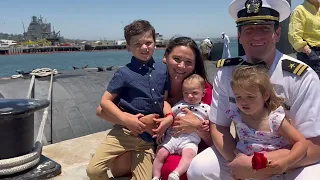 Navy Dad Meets baby for the first time at Submarine Homecoming