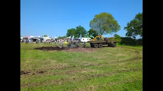 KRAZ pulling the tractor out of the mud