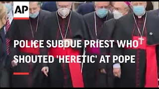 Police subdue priest who shouted 'heretic' at Pope