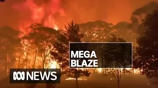 Homes believed lost in NSW 'mega blaze' as firefighters tackle 70-metre flames | ABC News