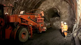 The largest tunnel in the world: miners facing the mountains