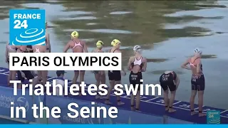 'What a special place to be in': Triathletes swim in the Seine ahead of Paris Olympics • FRANCE 24