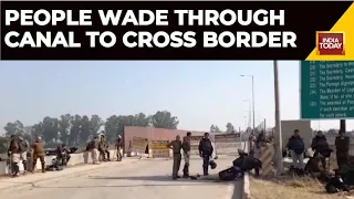 People Wade Through A Canal In Ambala To Cross The Border Of Farmers' 'Delhi Chalo' March