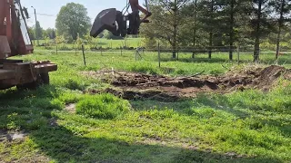 Poclain moving some dirt on the farm