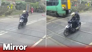 Moped narrowly avoids 70mph train at level crossing
