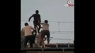 High Voltage Drama: Youth holds overhead train wires and then......