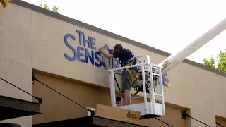 The Sensory Playce Construction   Putting up the Sign