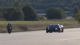 BMW S1000RR wheelie next to Bugatti Veyron Vitesse 1200 HP