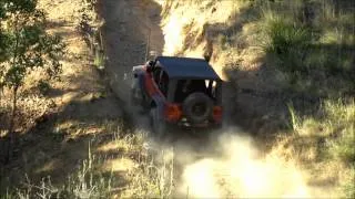 TJ Jeep nearly rolls while going up a steep hill climb