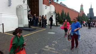 A joke with foreign tourists on Red Square when guard is changing. Moscow.