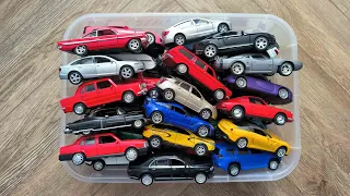 A Box Filled With Toy Cars From Different Brands