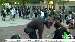 Police begin moving in on encampment at University of Michigan Diag