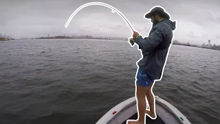 Fishing Durban Harbour in the rain during Cyclone Eloise, South Africa.