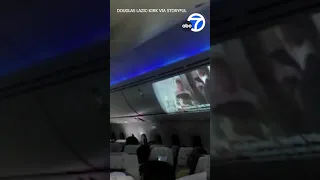 Airline passenger uses projector to create sky-high movie theater