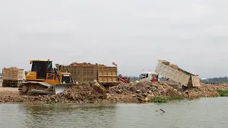 Powerful Next Generation Bulldozer Wheel Loader Through Rock Dirt Into Water Big project Landfill