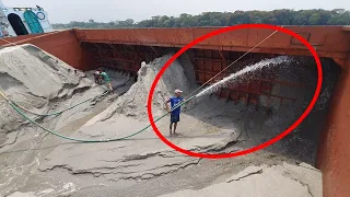 Relaxing sound and cool video with drager machine unloading sand on big barge ship river side