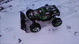 traxxas summit with plow pushing snow