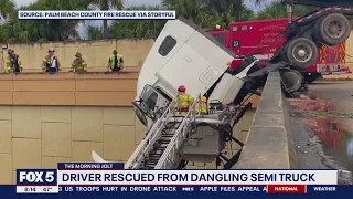 Video shows incredible rescue after driver gets stuck in semi-truck dangling from bridge