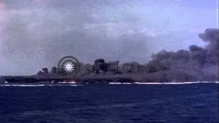 A Japanese kamikaze crashes near a United States super carrier and it burns in th...HD Stock Footage