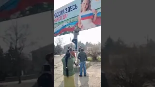 Ukrainians tearing down Russian propaganda billboards in their towns