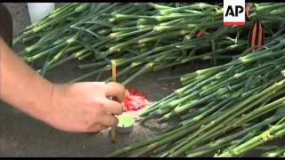 Mourners leave flowers for shot officer who killed Chechen girl