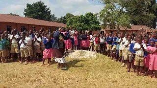 Enthusiastic pupils and teacher of Kitooma Primary School (Uganda) singing to welcome us.