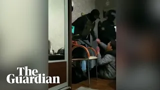 Footage shows Belarus policeman bursting through apartment looking for protesters