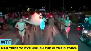 WTF. Brazilian Man Tries To Extinguish The Olympic Torch.