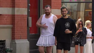 Sam Smith tries to beat the heat, white skirt & tank top while strolling with boyfriend NYC