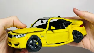 Crushed BMW in his hands, from PLASTILIN
