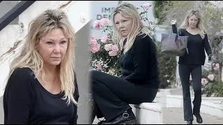 Turn that frown upside down! Forlorn Heather Locklear looks lost in thought as she sits on a curb