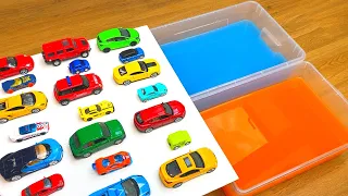 Various Diecast Model Cars Sliding Into The Yellow And Blue Water