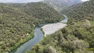 The Yuba River is running clear and cold past French Bar in French Ravine, 04/2024 - 4k drone video