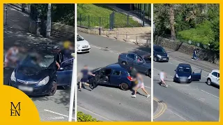 Moment fight breaks out between motorists on main road
