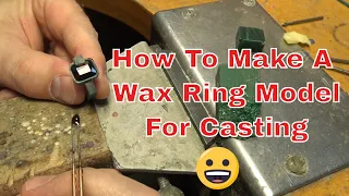 Wax carving a ring for a garnet setting.