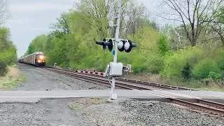 CSX 3027 leads a long westbound auto rack across Bolivar after passing Amtrak 63 Brocken down at 99