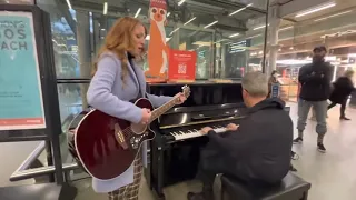 Girl Walks Through The Station With A Guitar....