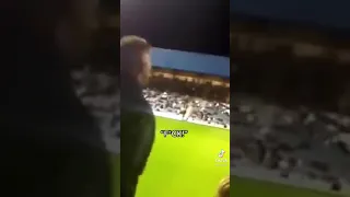 Football fan shouts abuse to the manager