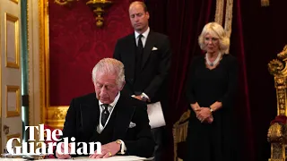 King Charles signals to aide to remove pens during signing of oath