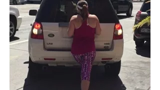 Crazy Woman trying to Block(Reserve) a Parking Spot with her Body, in Denver CO