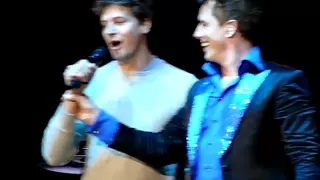 John Barrowman with his husband Scott Gill singing live