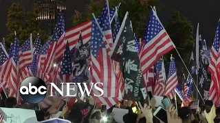 Thousands of protesters wave American flags in Hong Kong