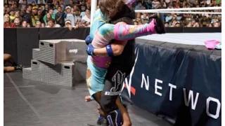 AJ Styles Styles Clash outside the ring to Xavier Woods