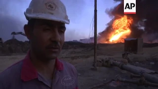 Iraqi firefighters try to put out burning oil wells