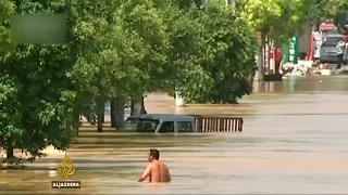 China floods kill scores, displace thousands