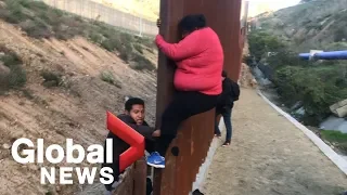 Migrant families continue to spill over Tijuana border fence, head to U.S.