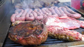 Italy Street Food Festival. Huge Asado, Blocks of Meat on Grill, Big Sausages, Ham and more Food